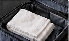 Illustrative travel towel packed in a bag